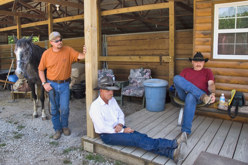 Ranch Hand Cowboys Rest Outside Stables FINAL(1).jpg :: Eagle Ranch trail ride and fun over Memorial Day Weekend, May 25 through 29, 2006.  Tim Stamm, Lee Ann Stamm, and Helen Phelps stayed together in a cabin.  Also in attendance were Crystal, an 18 year old Silkie Terrier, and Maggie, a 7 year old Great Dane.  Tim and Lee Ann rode their Kentucky Mountain Saddle Horses, Riley and Mr. Beau.   The trio ate food prepared in advance of the trip and went to Smith's in Collins for their famous pork tenderloin, chicken fried steak, and cobbler.