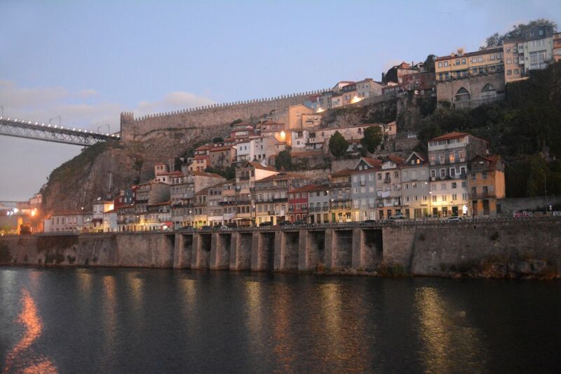 DC 22-0654-019.jpg :: Saga Douro River Cruise, Porto to Regua Lamego, River Douro: Early morning aboard the MS Douro Spirit departing Porto to Lamego. The steep banks of the Douro with the city walls above. Photo taken 30/08/2022