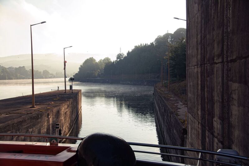 DC 22-0654-051.jpg :: Saga Douro River Cruise, Porto to Regua Lamego, River Douro: Early morning aboard the MS Douro Spirit departing Porto to Lamego. Crestuma–Lever Dam is a concrete gravity dam on the Douro. It is located in the municipality Vila Nova de Gaia, in Porto District. Construction of the dam began in 1976. The dam was completed in 1985. It is owned by Companhia Portuguesa de Produção de Electricidade (CPPE). On the left side of the dam is a lock, which can handle ships with the following maximum properties: 83 m in length, 11.40 m on the beam, 3.8 m load-draught and a cargo capacity of 2500 tons. The MS Douro Spirit inside the lock. The MS Douro Spirit departing the lock. Photo taken 30/08/2022