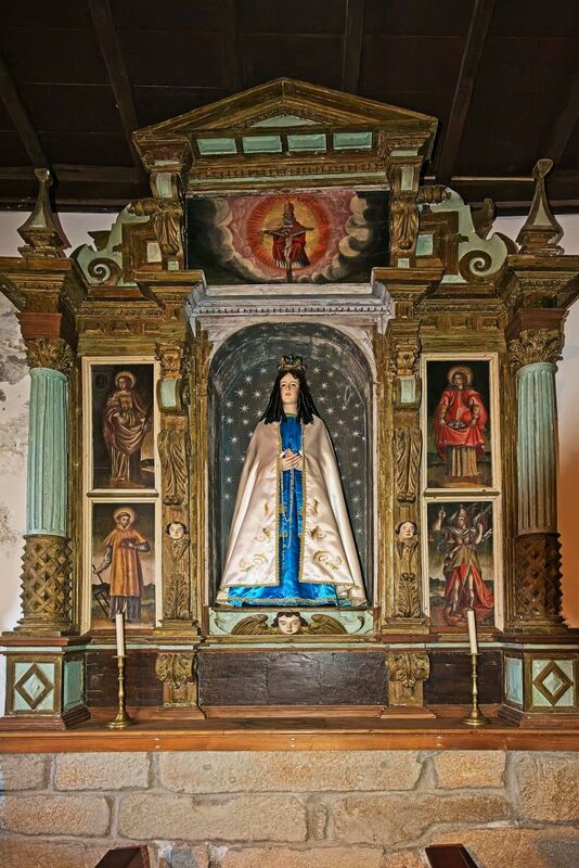 DC 22-0791-062.jpg :: Saga Douro River Cruise, Barca d'Alva, Castelo Rodrigo: The Mother Church is dedicated to Our Lady of Rocamador, and was founded in the thirteenth century by the Confraternity of the Friars of Our Lady of Rocamador, a congregation that was dedicated to assisting Compostela pilgrims. The Property maintains the primitive typology, it is an example of transition between Romanesque and Gothic, but it underwent later works, namely in the sixteenth and seventeenth centuries, which changed the structure of the temple. It has a composite plan, three naves, straight lintel porticoes and angular pediment. Inside we can admire a wooden coffered ceiling painted with hagiographic scenes, in the chancel eighteenth-century blue and white tiles and in the main altar Hispano-Arabic tiles. The Church was restored in the late 90s as part of the Historical Villages of Portugal Program. P.s. Alter, Our Lady of the Rosary, with its carving in the centre, with wood of saints painted on its sides and decorated with Solomonic columns with plant motifs. Photo taken 31/08/2022