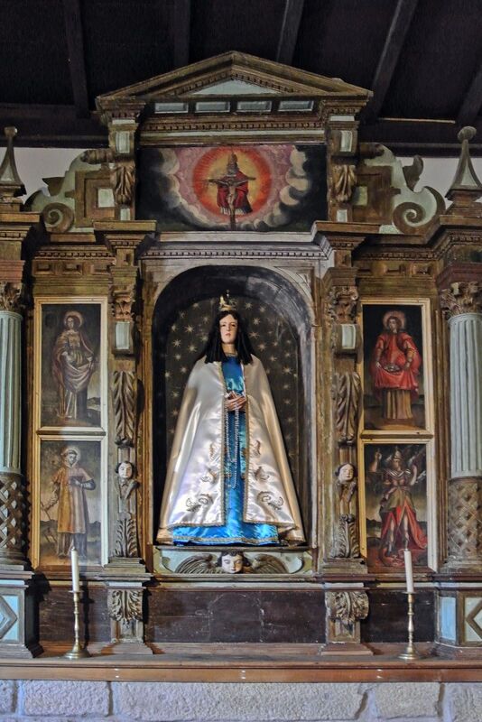 DC 22-0791-063.jpg :: Saga Douro River Cruise, Barca d'Alva, Castelo Rodrigo: The Mother Church is dedicated to Our Lady of Rocamador, and was founded in the thirteenth century by the Confraternity of the Friars of Our Lady of Rocamador, a congregation that was dedicated to assisting Compostela pilgrims. The Property maintains the primitive typology, it is an example of transition between Romanesque and Gothic, but it underwent later works, namely in the sixteenth and seventeenth centuries, which changed the structure of the temple. It has a composite plan, three naves, straight lintel porticoes and angular pediment. Inside we can admire a wooden coffered ceiling painted with hagiographic scenes, in the chancel eighteenth-century blue and white tiles and in the main altar Hispano-Arabic tiles. The Church was restored in the late 90s as part of the Historical Villages of Portugal Program. P.s. Alter, Our Lady of the Rosary, with its carving in the centre, with wood of saints painted on its sides and decorated with Solomonic columns with plant motifs. Photo taken 31/08/2022