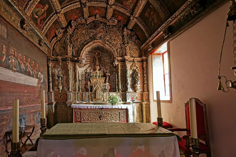 DC 22-0791-066.jpg :: Saga Douro River Cruise, Barca d'Alva, Castelo Rodrigo: The Mother Church is dedicated to Our Lady of Rocamador, and was founded in the thirteenth century by the Confraternity of the Friars of Our Lady of Rocamador, a congregation that was dedicated to assisting Compostela pilgrims. The Property maintains the primitive typology, it is an example of transition between Romanesque and Gothic, but it underwent later works, namely in the sixteenth and seventeenth centuries, which changed the structure of the temple. It has a composite plan, three naves, straight lintel porticoes and angular pediment. Inside we can admire a wooden coffered ceiling painted with hagiographic scenes, in the chancel eighteenth-century blue and white tiles and in the main altar Hispano-Arabic tiles. The Church was restored in the late 90s as part of the Historical Villages of Portugal Program. Photo taken 31/08/2022