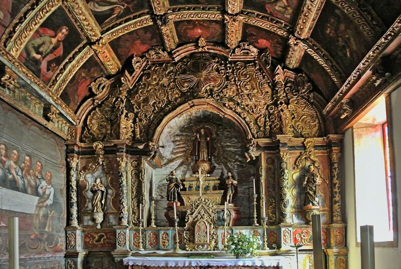 DC 22-0791-068.jpg :: Saga Douro River Cruise, Barca d'Alva, Castelo Rodrigo: The Mother Church is dedicated to Our Lady of Rocamador, and was founded in the thirteenth century by the Confraternity of the Friars of Our Lady of Rocamador, a congregation that was dedicated to assisting Compostela pilgrims. The Property maintains the primitive typology, it is an example of transition between Romanesque and Gothic, but it underwent later works, namely in the sixteenth and seventeenth centuries, which changed the structure of the temple. It has a composite plan, three naves, straight lintel porticoes and angular pediment. Inside we can admire a wooden coffered ceiling painted with hagiographic scenes, in the chancel eighteenth-century blue and white tiles and in the main altar Hispano-Arabic tiles. The Church was restored in the late 90s as part of the Historical Villages of Portugal Program. Photo taken 31/08/2022