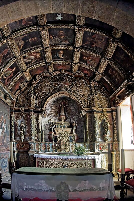 DC 22-0791-070.jpg :: Saga Douro River Cruise, Barca d'Alva, Castelo Rodrigo: The Mother Church is dedicated to Our Lady of Rocamador, and was founded in the thirteenth century by the Confraternity of the Friars of Our Lady of Rocamador, a congregation that was dedicated to assisting Compostela pilgrims. The Property maintains the primitive typology, it is an example of transition between Romanesque and Gothic, but it underwent later works, namely in the sixteenth and seventeenth centuries, which changed the structure of the temple. It has a composite plan, three naves, straight lintel porticoes and angular pediment. Inside we can admire a wooden coffered ceiling painted with hagiographic scenes, in the chancel eighteenth-century blue and white tiles and in the main altar Hispano-Arabic tiles. The Church was restored in the late 90s as part of the Historical Villages of Portugal Program. Photo taken 31/08/2022