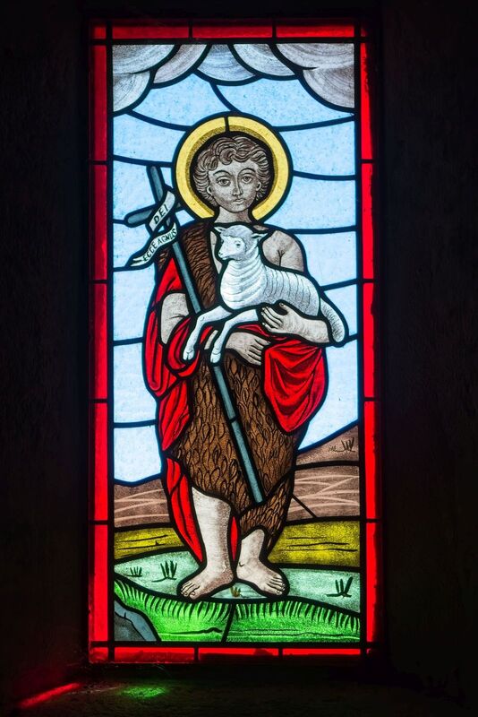 DC 22-0791-075.jpg :: Saga Douro River Cruise, Barca d'Alva, Castelo Rodrigo: The Mother Church is dedicated to Our Lady of Rocamador, and was founded in the thirteenth century by the Confraternity of the Friars of Our Lady of Rocamador, a congregation that was dedicated to assisting Compostela pilgrims. The Property maintains the primitive typology, it is an example of transition between Romanesque and Gothic, but it underwent later works, namely in the sixteenth and seventeenth centuries, which changed the structure of the temple. It has a composite plan, three naves, straight lintel porticoes and angular pediment. Inside we can admire a wooden coffered ceiling painted with hagiographic scenes, in the chancel eighteenth-century blue and white tiles and in the main altar Hispano-Arabic tiles. The Church was restored in the late 90s as part of the Historical Villages of Portugal Program. P.s Stained glass window showing The Good Shepherd. Photo taken 31/08/2022