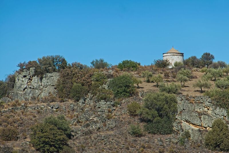DC 22-0791-108.jpg :: Saga Douro River Cruise, Barca d'Alva,Sapinha:  Sapinha refers to the Miradouro Natural do Alto da Sapinha, a scenic viewpoint in Portugal offering views of the Douro River and its cliffs. It is a popular spot for its impressive, sweeping vistas, which are especially beautiful for birdwatching and visualizing the border between Portugal and Spain. The viewpoint is accessible by road, located near Figueira de Castelo Rodrigo, and is known for the breathtaking views it provides of the river valley. The image features a traditional dovecote, located in the historic village of Castelo Rodrigo. This type of structure, known as a pombais in Portuguese, was historically used for housing pigeons or doves. Photo taken 31/08/2022