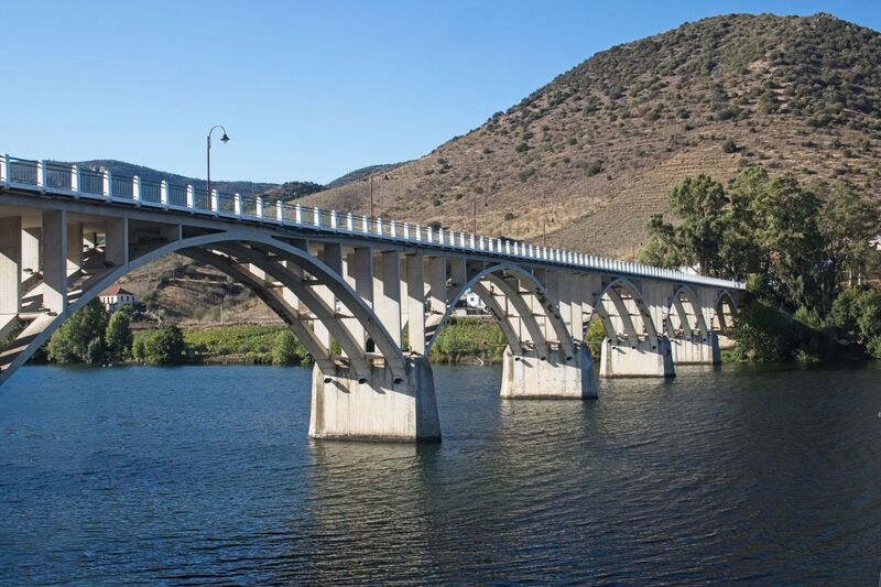 DC 22-0791-124.jpg :: Saga Douro River Cruise, Barca d'Alva:  The Almirante Sarmento Rodrigues Bridge, also known as the Highway Bridge of Barca d'Alva, is a road bridge over the Douro River, located near the village of Barca d'Alva in Portugal. It was designed by Edgar Cardoso, opened in 1955, and carries national route N221, connecting Portugal and Spain. It is the first highway bridge on the Portuguese section of the Douro River. Photo taken 31/08/2022