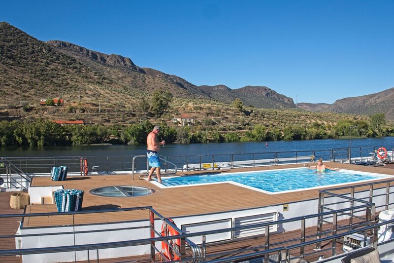 DC 22-0791-130.jpg :: Saga Douro River Cruise, Barca d'Alva: The MS Douro Spirit moored up at Barca d'Alva and passengers taking advantage of the warm weather to bathe in the ship deck pool. Photo taken 31/08/2022