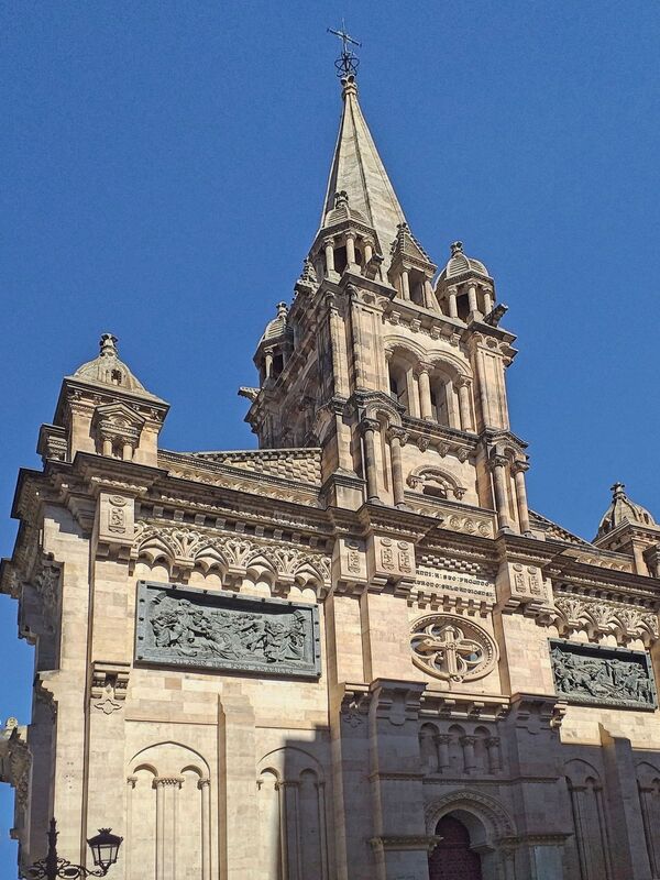 DC 22-0794-095.jpg :: Saga Douro River Cruise, Salamanca. Spain: The Church of Saint John of Sahagún (Iglesia de San Juan de Sahagún), located in Salamanca. The church is situated on Toro Street, a short walk from the Plaza Mayor. It is built in a Neo-Romanesque style. The church was constructed in the late 19th century, with work beginning in 1896, and dedicated to the city's patron saint, Saint John of Sahagún. The facade is notable for its detailed carvings that depict various miracles attributed to San Juan de Sahagún. Photo taken 01/09/2022