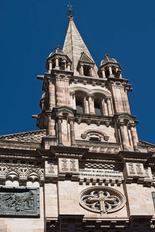 DC 22-0794-096.jpg :: Saga Douro River Cruise, Salamanca. Spain: The Church of Saint John of Sahagún (Iglesia de San Juan de Sahagún), located in Salamanca. The church is situated on Toro Street, a short walk from the Plaza Mayor. It is built in a Neo-Romanesque style. The church was constructed in the late 19th century, with work beginning in 1896, and dedicated to the city's patron saint, Saint John of Sahagún. The facade is notable for its detailed carvings that depict various miracles attributed to San Juan de Sahagún. Photo taken 01/09/2022