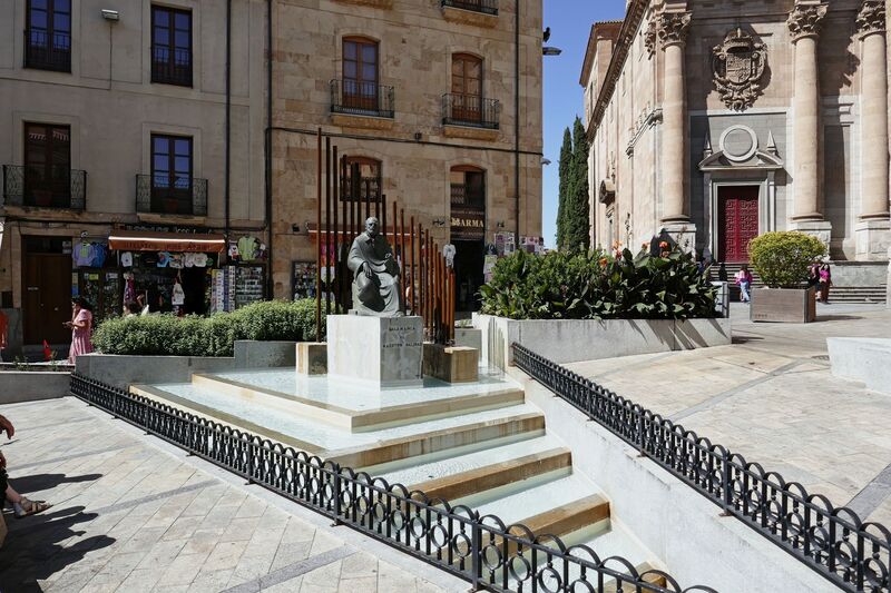 DC 22-0794-165.jpg :: Saga Douro River Cruise, Salamanca. Spain: The Monumento al Maestro Salinas (Monument to Maestro Salinas). The bronze sculpture, created by Hipólito Pérez Calvo and inaugurated in 1993, honours the life and work of Francisco de Salinas, a renowned 16th-century Spanish music theorist and organist. The statue depicts Francisco de Salinas, who became blind at age eleven but went on to become a famous musician and a professor of music at the University of Salamanca for over 20 years. The monument is situated in a triangular square at the intersection of Rúa Antigua, Rúa Mayor, and Calle Compañía. It is next to other significant landmarks, including the historic Casa de las Conchas and the Clerecía church (Pontifical University building). Photo taken 01/09/2022