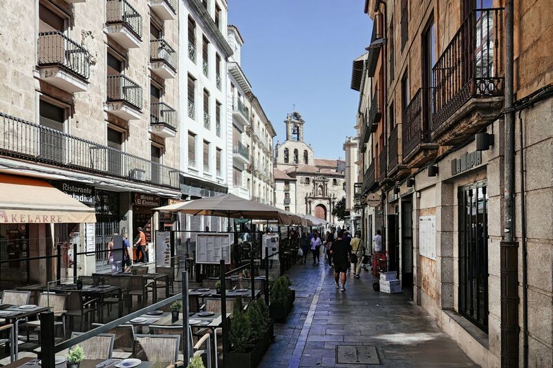 DC 22-0794-175.jpg :: Saga Douro River Cruise, Salamanca. Spain: View down the Rúa Mayor, a pedestrian street in the historic centre of Salamanca. The street leads toward the bell tower of the city's cathedral complex. The street is lined with historic buildings, shops, and outdoor cafes (tapas bars). Photo taken 01/09/2022