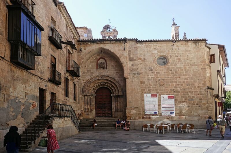 DC 22-0794-183.jpg :: Saga Douro River Cruise, Salamanca. Spain: Church of San Martín de Tours located in Salamanca. The church is situated in the Plaza del Corrillo, adjacent to the Plaza Mayor. It is a Romanesque-style Catholic church, one of the oldest in the city. The building features a prominent arched doorway and a small bell tower on the roof. The surrounding area is a public square with outdoor seating for nearby establishments. Photo taken 01/09/2022