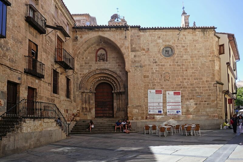 DC 22-0794-184.jpg :: Saga Douro River Cruise, Salamanca. Spain: Church of San Martín de Tours located in Salamanca. The church is situated in the Plaza del Corrillo, adjacent to the Plaza Mayor. It is a Romanesque-style Catholic church, one of the oldest in the city. The building features a prominent arched doorway and a small bell tower on the roof. The surrounding area is a public square with outdoor seating for nearby establishments. Photo taken 01/09/2022