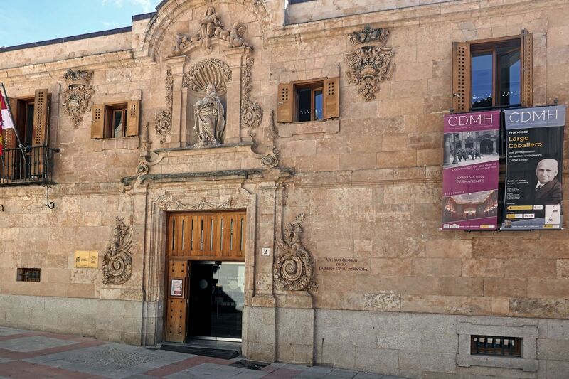 DC 22-0794-193.jpg :: Saga Douro River Cruise, Salamanca. Spain: The Centro Documental de la Memoria Histórica (Documentary Centre of Historical Memory), also known as the General Archive of the Spanish Civil War. This museum and archive is dedicated to the history of the Spanish Civil War, the Francoist dictatorship, and Freemasonry. It is situated in the historic city of Salamanca, specifically at Calle de el Expolio, 2 (or Calle Gibraltar, 2). The centre holds extensive archives including over 2000 posters from the Civil War, documents, photographs, and artifacts, with free admission. A notable permanent exhibit is a recreation of a Masonic lodge using confiscated objects. The posters visible on the building advertise an exhibition related to Francisco Largo Caballero, a prominent Spanish socialist leader during the Second Republic and the Civil War. Photo taken 01/09/2022