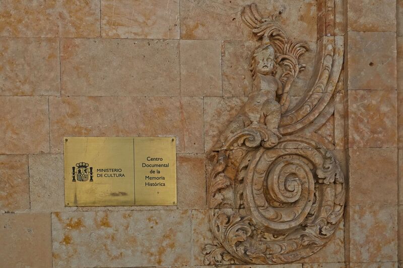 DC 22-0794-195.jpg :: Saga Douro River Cruise, Salamanca. Spain: The Centro Documental de la Memoria Histórica (Documentary Centre of Historical Memory), also known as the General Archive of the Spanish Civil War. This museum and archive is dedicated to the history of the Spanish Civil War, the Francoist dictatorship, and Freemasonry. It is situated in the historic city of Salamanca, specifically at Calle de el Expolio, 2 (or Calle Gibraltar, 2). The centre holds extensive archives including over 2000 posters from the Civil War, documents, photographs, and artifacts, with free admission. A notable permanent exhibit is a recreation of a Masonic lodge using confiscated objects. The posters visible on the building advertise an exhibition related to Francisco Largo Caballero, a prominent Spanish socialist leader during the Second Republic and the Civil War. Photo taken 01/09/2022