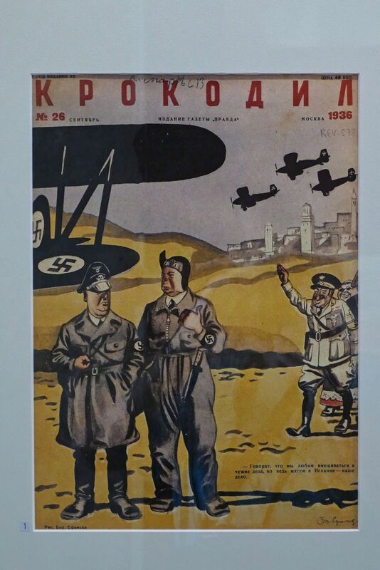 DC 22-0794-201.jpg :: Saga Douro River Cruise, Salamanca. Spain: General Archive of the Spanish Civil War in Salamanca. The image displays the cover of a 1936 issue of Krokodil magazine, a Soviet satirical publication. The cover features a political cartoon depicting figures resembling Adolf Hitler and Benito Mussolini, with a caption in Russian. Photo taken 01/09/2022