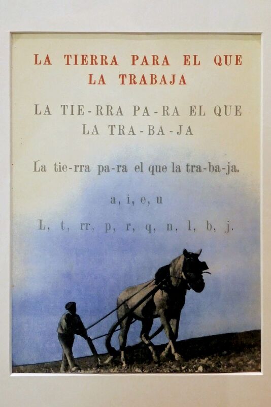DC 22-0794-206.jpg :: Saga Douro River Cruise, Salamanca. Spain: General Archive of the Spanish Civil War in Salamanca The image displays a poster featuring a photograph of a person ploughing a field with a horse, accompanied by the Spanish phrase \