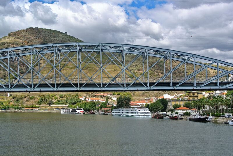 DC 22-0797-067.jpg :: Saga Douro River Cruise, Pocinho to Pinhao, River Douro: The Ponte do Pinhão, a steel road bridge crossing the Douro River in the village of Pinhão, Portugal. This bridge is often referred to as the Gustave Eiffel bridge as it was designed by the famous French engineer Gustave Eiffel and his firm. Spans the Douro River in Pinhão, Portugal, connecting both banks of the river in the heart of the Alto Douro Wine Region. Opened in 1903. It was designed in the late 19th century. It is a road bridge that carries traffic and has pedestrian walkways, serving as an essential link for local residents and a scenic spot for tourists. Photo taken 02/09/2022