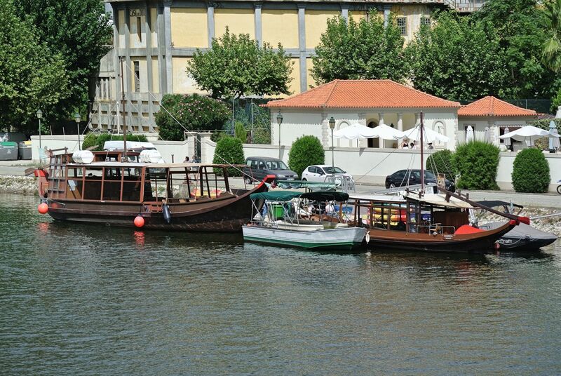 DC 22-0797-079.jpg :: Saga Douro River Cruise, Pocinho to Pinhao, River Douro: The village pictured in the image is Pinhão, a picturesque town nestled in the heart of Portugal's renowned Douro Valley wine region. The image shows the town from across the Douro River, featuring its distinctive iron bridge and the surrounding terraced hills covered in vineyards. Pinhão is located in the Norte Region of Portugal, within the Douro Valley, which is a UNESCO World Heritage site known for its stunning landscapes and port wine production. Photo taken 02/09/2022