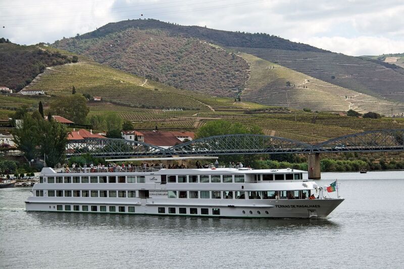 DC 22-0797-093.jpg :: Saga Douro River Cruise, Pocinho to Pinhao, River Douro: Berthed in Pinhao, the MS Fernão de Magalhães, a river cruise ship that sails on the Douro River in Portugal and Spain. It is operated by the French shipping company CroisiEurope and is named after the famous Portuguese navigator Ferdinand Magellan. Just embarking for its next port of call. Photo taken 02/09/2022