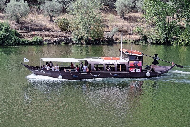 DC 22-0797-097.jpg :: Saga Douro River Cruise, Pocinho to Pinhao, River Douro: A traditional Portuguese rabelo boat offering a tourist cruise on the Douro River from Pinhao. These boats were historically used to transport port wine barrels from the vineyards downriver to the cellars in Porto. The boat is branded \