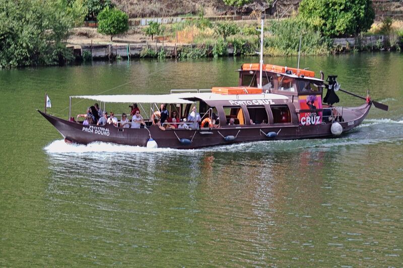 DC 22-0797-098.jpg :: Saga Douro River Cruise, Pocinho to Pinhao, River Douro: A traditional Portuguese rabelo boat offering a tourist cruise on the Douro River from Pinhao. These boats were historically used to transport port wine barrels from the vineyards downriver to the cellars in Porto. The boat is branded \