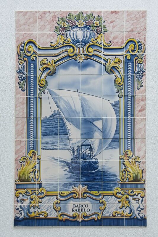 DC 22-0797-114.jpg :: Saga Douro River Cruise, Pocinho to Pinhao, River Douro: Hand-painted azulejo, ceramic tile with motif Rabelo boat for the transport of wine barrels, wine region Alto Douro at Cais da Foz restaurant, Sabrosa Pinhao. Photo taken 02/09/2022