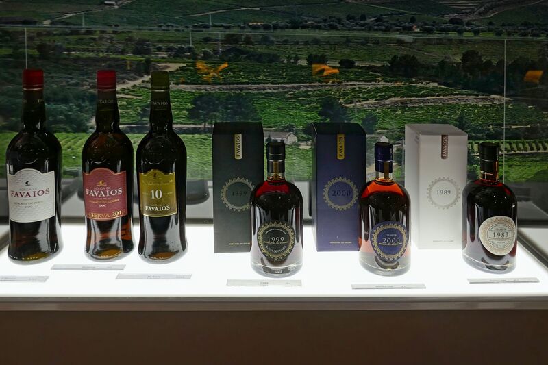 DC 22-0808-061.jpg :: Saga Douro River Cruise, Favaios:  The building in the image is the Adega Cooperativa de Favaios, a renowned winery located in the village of Favaios within the Douro wine region of Portugal. The winery is famous for producing one of Portugal's most iconic fortified wines, Moscatel de Favaios. The winery is nestled in the picturesque Alto Douro wine region of Portugal, a UNESCO World Heritage site. Founded in 1952, the cooperative was established by local producers to create their famous Moscatel wine. While most famous for its Moscatel, the winery also produces DOC Douro wines (white, red, and rosé), sparkling wines, and Port wine. Adega de Favaios Wines available for purchase. Photo taken 02/09/2022