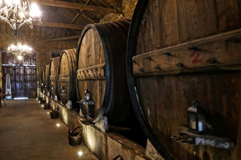 DC 22-0808-070.jpg :: Saga Douro River Cruise, Favaios, Avessada Wine Estate: Quinta da Avessada is located in the centre of the Douro demarcated region at its highest point (at an altitude of 600 meters) and the flattest point in the whole region (about 1,000ha of plateau), consisting of four buildings (one of them is one hundred years old) and 25ha of planting. Due to this, 90% of its plantation is destined to the production of Muscat grapes, with which Moscatel de Favaios is produced, and is designated a national apéritif. It is the Wine-Growing Village of Favaios. Vault of wine barrels. Photo taken 02/09/2022