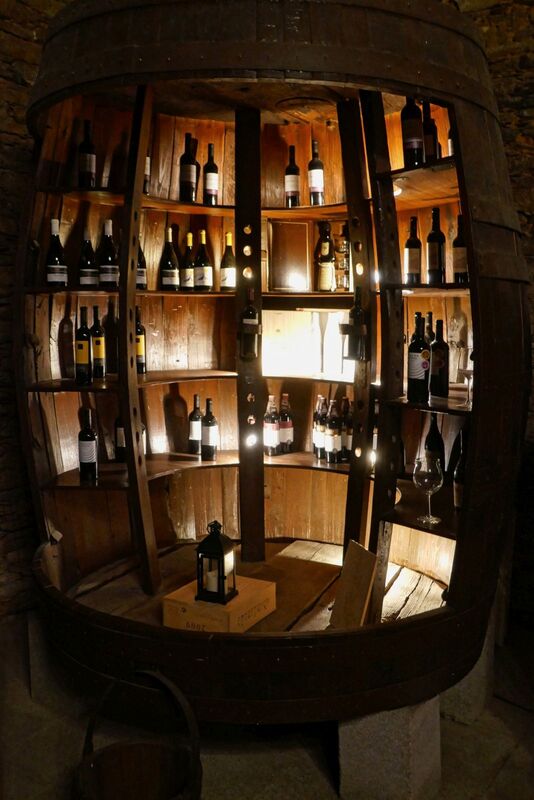 DC 22-0808-073.jpg :: Saga Douro River Cruise, Favaios, Avessada Wine Estate: Quinta da Avessada is located in the centre of the Douro demarcated region at its highest point (at an altitude of 600 meters) and the flattest point in the whole region (about 1,000ha of plateau), consisting of four buildings (one of them is one hundred years old) and 25ha of planting. Due to this, 90% of its plantation is destined to the production of Muscat grapes, with which Moscatel de Favaios is produced, and is designated a national apéritif. It is the Wine-Growing Village of Favaios. Large barrel wine display. Photo taken 02/09/2022