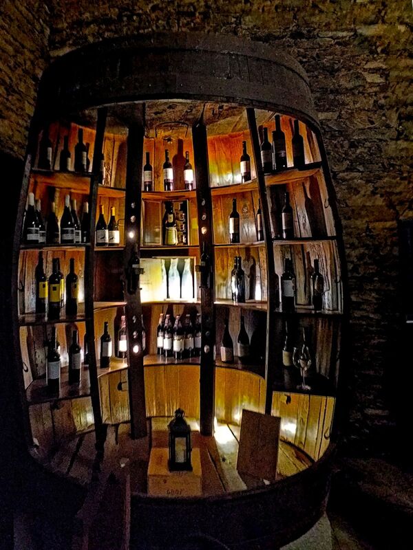 DC 22-0808-074.jpg :: Saga Douro River Cruise, Favaios, Avessada Wine Estate: Quinta da Avessada is located in the centre of the Douro demarcated region at its highest point (at an altitude of 600 meters) and the flattest point in the whole region (about 1,000ha of plateau), consisting of four buildings (one of them is one hundred years old) and 25ha of planting. Due to this, 90% of its plantation is destined to the production of Muscat grapes, with which Moscatel de Favaios is produced, and is designated a national apéritif. It is the Wine-Growing Village of Favaios. Large barrel wine display. Photo taken 02/09/2022