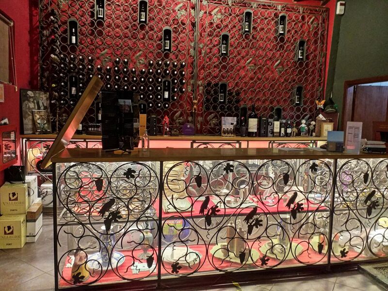 DC 22-0808-078.jpg :: Saga Douro River Cruise, Favaios, Avessada Wine Estate: Quinta da Avessada is located in the centre of the Douro demarcated region at its highest point (at an altitude of 600 meters) and the flattest point in the whole region (about 1,000ha of plateau), consisting of four buildings (one of them is one hundred years old) and 25ha of planting. Due to this, 90% of its plantation is destined to the production of Muscat grapes, with which Moscatel de Favaios is produced, and is designated a national apéritif. It is the Wine-Growing Village of Favaios. Wine sales counter. Photo taken 02/09/2022