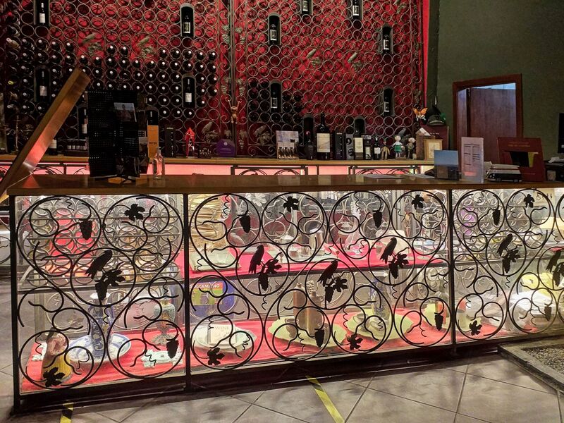 DC 22-0808-079.jpg :: Saga Douro River Cruise, Favaios, Avessada Wine Estate: Quinta da Avessada is located in the centre of the Douro demarcated region at its highest point (at an altitude of 600 meters) and the flattest point in the whole region (about 1,000ha of plateau), consisting of four buildings (one of them is one hundred years old) and 25ha of planting. Due to this, 90% of its plantation is destined to the production of Muscat grapes, with which Moscatel de Favaios is produced, and is designated a national apéritif. It is the Wine-Growing Village of Favaios. Wine sales counter. Photo taken 02/09/2022