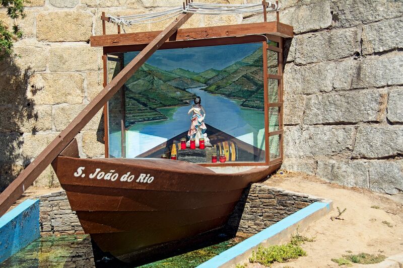 DC 22-0809-013.jpg :: Saga Douro River Cruise, Pinhao to Regua, Portugal: Image shows a religious monument or geocache known as S. João do Rio, located in the city of Peso da Régua, Portugal. The monument is shaped like a traditional wooden boat, characteristic of those used on the Douro River. Inside the boat's \