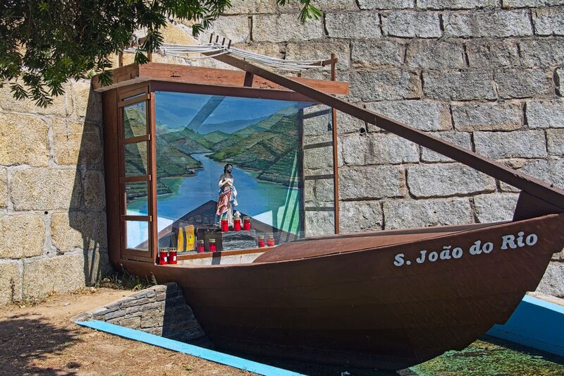 DC 22-0809-014.jpg :: Saga Douro River Cruise, Pinhao to Regua, Portugal: Image shows a religious monument or geocache known as S. João do Rio, located in the city of Peso da Régua, Portugal. The monument is shaped like a traditional wooden boat, characteristic of those used on the Douro River. Inside the boat's \
