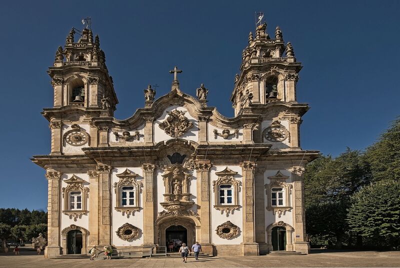 DC 22-0810-001.jpg :: Saga Douro River Cruise, Santuario de Nossa Senhora dos Remedios and Regua: The Santuário de Nossa Senhora dos Remédios (Sanctuary of Our Lady of Remedies), a famous pilgrimage site and 18th-century Baroque sanctuary in Lamego, Portugal. The sanctuary is a prominent example of Baroque-style architecture, known for its highly ornate and detailed façade. The site's most iconic feature is a magnificent zigzagging staircase leading up to the church. It consists of 686 steps across nine terraces. The complex is embellished with decorative fountains, statues, and terraced gardens at each level of the staircase. One notable fountain outside is said by some to have healing waters. It is situated atop the Hill of St. Stephen (Monte de Santo Estêvão), offering panoramic views of the town of Lamego and the surrounding Douro Valley. Construction of the present Baroque shrine began in the mid-18th century, though the site has earlier religious roots as a hermitage. Today, it remains one of the major pilgrimage centres in Portugal, where pilgrims traditionally climb the hundreds of steps as an act of reflection and meditation. Photo taken 03/09/2022