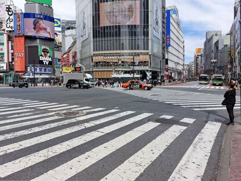 DC 23-0677-043.jpg :: Iglu Tour, Ultimate Japan & Cherry Blossom: Tokyo, Japan. The most famous pedestrian crossing in Tokyo is the Shibuya Crossing, also known as the Shibuya Scramble Crossing. It's the world's busiest pedestrian crossing, with thousands of people crossing simultaneously when the lights turn red for cars. This iconic landmark is located in front of Shibuya Station's Hachiko exit and is a must-see for any visitor to Tokyo. Photo taken 31/03/2023