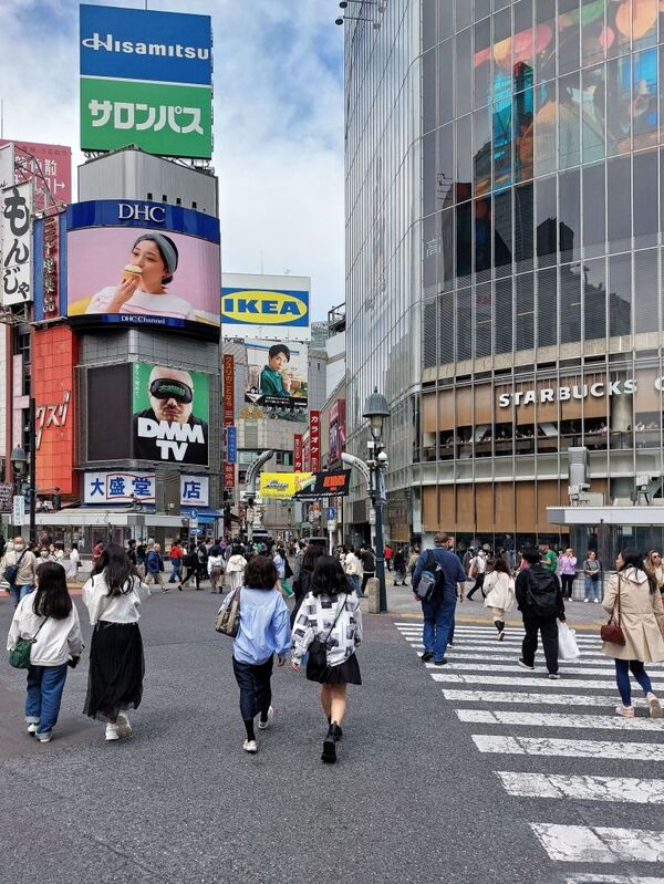 DC 23-0677-045.jpg :: Iglu Tour, Ultimate Japan & Cherry Blossom: Tokyo, Japan. The most famous pedestrian crossing in Tokyo is the Shibuya Crossing, also known as the Shibuya Scramble Crossing. It's the world's busiest pedestrian crossing, with thousands of people crossing simultaneously when the lights turn red for cars. This iconic landmark is located in front of Shibuya Station's Hachiko exit and is a must-see for any visitor to Tokyo. Photo taken 31/03/2023