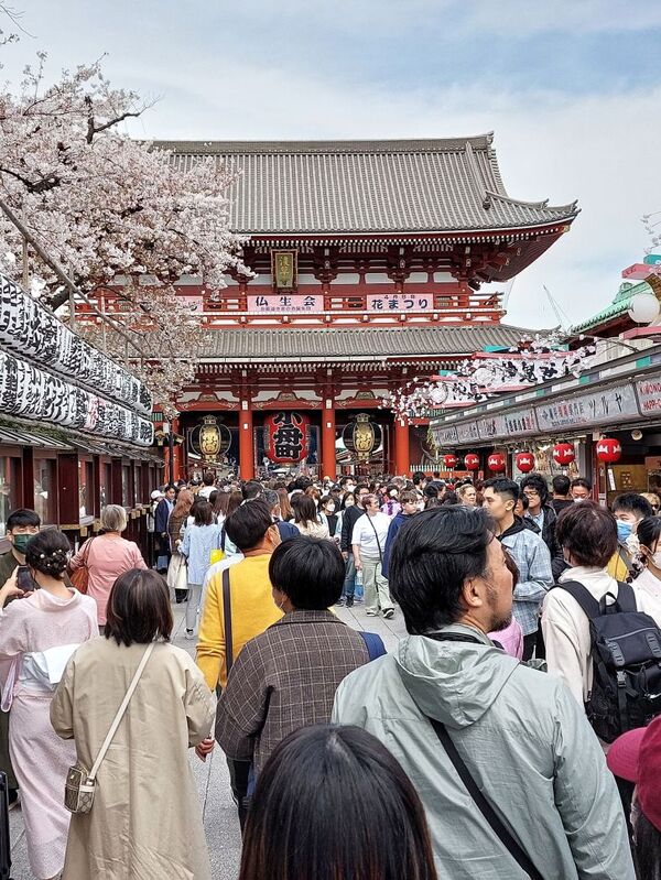 DC 23-0677-077.jpg :: Iglu Tour, Ultimate Japan & Cherry Blossom: Tokyo, Japan. Senso-ji, widely known as Asakusa Kannon Temple, is Tokyo’s oldest Buddhist temple. Located in Asakusa, one of Tokyo’s most lively and busy districts, Senso-ji is one of the most visited spiritual sites in the world. This bright and colourful temple attracts so many people from all over the world that at times it’s even hard to walk around the temple grounds. Senso-ji was founded almost one and half millennia ago, in 645. The legend says that in 628 two fishermen caught a statue of Kannon, the goddess of compassion, in the nearby Sumida River. They tried to get rid of it, but it kept coming back to them. Taking it as a sign, the head of the fishermen’s village erected Senso-ji in honour of Kannon. The temple holds the original Kannon statue; however it can never be seen by the public and is supposedly stored safely inside 3 boxes. P.s. Nakamise Dori, senso-ji. Nakamise Dori is a street full of stalls and small shops. The street stretches from the Kaminarimon Gate to the Hozomon Gate. Shops sell everything from souvenirs to snacks, toys and clothes. The street of Nakamise dates way back. Under the Tokugawa clans ruling locals who served visitors to the Senso-ji temple were given permissions to put up stalls on the street leading up to the temple. This is considered the beginning of Nakamise Dori as a shopping street. During the Meiji Restoration, when Senso-ji was converted to a park, the stall owners were kicked out by the government and western style buildings were constructed in 1885. These buildings were destroyed in a large earthquake in 1923. The shopping street was rebuilt in what was supposedly a magnificent and beautiful vermilion-lacquered style but was completely destroyed again during World War 2. At the rear Hozomon Gate – second gate. Photo taken 31/03/2023