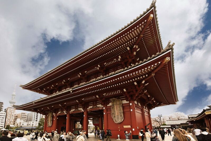 DC 23-0677-088.jpg :: Iglu Tour, Ultimate Japan & Cherry Blossom: Tokyo, Japan. Senso-ji, widely known as Asakusa Kannon Temple, is Tokyo’s oldest Buddhist temple. Located in Asakusa, one of Tokyo’s most lively and busy districts, Senso-ji is one of the most visited spiritual sites in the world. This bright and colourful temple attracts so many people from all over the world that at times it’s even hard to walk around the temple grounds. Senso-ji was founded almost one and half millennia ago, in 645. The legend says that in 628 two fishermen caught a statue of Kannon, the goddess of compassion, in the nearby Sumida River. They tried to get rid of it, but it kept coming back to them. Taking it as a sign, the head of the fishermen’s village erected Senso-ji in honor of Kannon. The temple holds the original Kannon statue; however it can never be seen by the public and is supposedly stored safely inside 3 boxes. P.s. Hozomon Gate – second gate. The second gate “Hozomon” leading to Senso-ji temple is also known as “Treasure-house gate”. The gate has a very unique look with it’s two floors. On the second floor, many of the temples treasures are stored, hence the name “Treasure-house gate”. The gate is decorated with three large lanterns and is protected by two Nio statues on the front face. The backside displays two large straw sandals. Like the Kaminarimon Gate this gate was also burned down and rebuilt on several occasions over the years. The current gate is from 1964 and is built in reinforced concrete and fire-resistant materials. At the back of the Hozomon gate you will most likely notice the two gigantic straw sandals hung up on the wall. Many questions pop into mind here. Firstly, why sandals? secondly why so big? Strange as this may seem today, sandals have been common offerings for temples when people came to pray. The explanation of the sandals apparently is that people would pray for their legs and lower body, as this part of the body was crucial for being able to work hence earn for food. The large size of the sandals is not common though. There appears to be a few different stories of why the sandals are there, but common for all the stories is that the huge sandals are offered to Senso-ji temple by the city of Maruyama in Yamagata, some 400km / 250mi from Tokyo. Every 10 years the city gets together and create a new pair of sandals which are donated to Senso-ji. Photo taken 31/03/2023