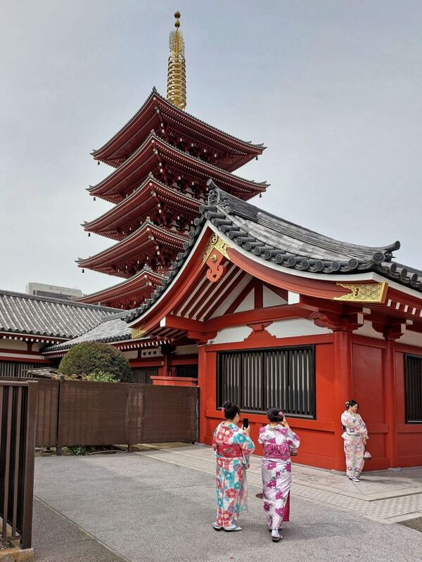 DC 23-0677-092.jpg :: Iglu Tour, Ultimate Japan & Cherry Blossom: Tokyo, Japan. Senso-ji, widely known as Asakusa Kannon Temple, is Tokyo’s oldest Buddhist temple. Located in Asakusa, one of Tokyo’s most lively and busy districts, Senso-ji is one of the most visited spiritual sites in the world. This bright and colourful temple attracts so many people from all over the world that at times it’s even hard to walk around the temple grounds. Senso-ji was founded almost one and half millennia ago, in 645. The legend says that in 628 two fishermen caught a statue of Kannon, the goddess of compassion, in the nearby Sumida River. They tried to get rid of it, but it kept coming back to them. Taking it as a sign, the head of the fishermen’s village erected Senso-ji in honour of Kannon. The temple holds the original Kannon statue; however, it can never be seen by the public and is supposedly stored safely inside 3 boxes. P.s. This five-stored pagoda inside the grounds of a popular tourist spot, Senso-ji Temple is a typical tower found in many Buddhist temples in Japan. Inside the pagoda, the remains of Buddha, the founder of Buddhism is placed. The original pagoda was constructed in 942. However, it has been successively lost by fire and subsequently reconstructed. The current pagoda was rebuilt in 1973 over the reinforced concrete base building and is 53.32 meters high. It becomes a popular sightseeing spot also for foreign visitors and draws attention. Photo taken 31/03/2023
