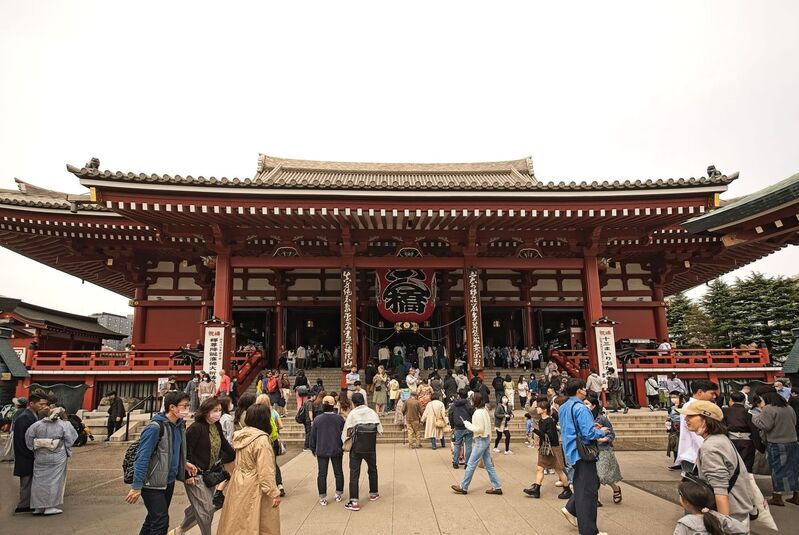 DC 23-0677-109.jpg :: Iglu Tour, Ultimate Japan & Cherry Blossom: Tokyo, Japan. Senso-ji, widely known as Asakusa Kannon Temple, is Tokyo’s oldest Buddhist temple. Located in Asakusa, one of Tokyo’s most lively and busy districts, Senso-ji is one of the most visited spiritual sites in the world. This bright and colourful temple attracts so many people from all over the world that at times it’s even hard to walk around the temple grounds. Senso-ji was founded almost one and half millennia ago, in 645. The legend says that in 628 two fishermen caught a statue of Kannon, the goddess of compassion, in the nearby Sumida River. They tried to get rid of it, but it kept coming back to them. Taking it as a sign, the head of the fishermen’s village erected Senso-ji in honour of Kannon. The temple holds the original Kannon statue; however, it can never be seen by the public and is supposedly stored safely inside 3 boxes. Photo taken 31/03/2023