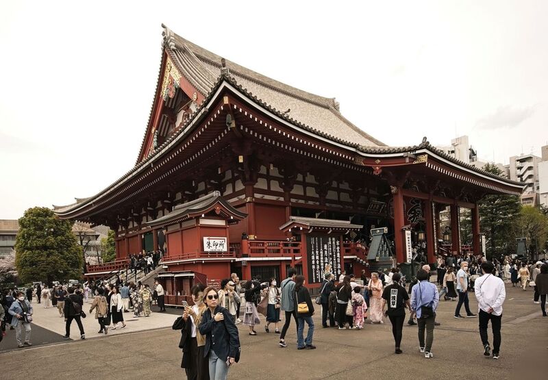 DC 23-0677-112.jpg :: Iglu Tour, Ultimate Japan & Cherry Blossom: Tokyo, Japan. Senso-ji, widely known as Asakusa Kannon Temple, is Tokyo’s oldest Buddhist temple. Located in Asakusa, one of Tokyo’s most lively and busy districts, Senso-ji is one of the most visited spiritual sites in the world. This bright and colourful temple attracts so many people from all over the world that at times it’s even hard to walk around the temple grounds. Senso-ji was founded almost one and half millennia ago, in 645. The legend says that in 628 two fishermen caught a statue of Kannon, the goddess of compassion, in the nearby Sumida River. They tried to get rid of it, but it kept coming back to them. Taking it as a sign, the head of the fishermen’s village erected Senso-ji in honour of Kannon. The temple holds the original Kannon statue; however, it can never be seen by the public and is supposedly stored safely inside 3 boxes. Photo taken 31/03/2023