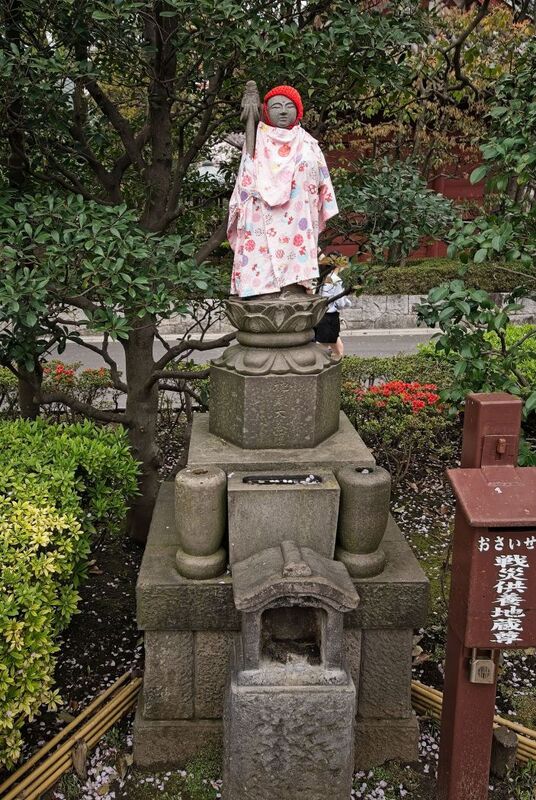 DC 23-0677-142.jpg :: Iglu Tour, Ultimate Japan & Cherry Blossom: Tokyo, Japan. Senso-ji, widely known as Asakusa Kannon Temple, is Tokyo’s oldest Buddhist temple. Located in Asakusa, one of Tokyo’s most lively and busy districts, Senso-ji is one of the most visited spiritual sites in the world. This bright and colourful temple attracts so many people from all over the world that at times it’s even hard to walk around the temple grounds. Senso-ji was founded almost one and half millennia ago, in 645. The legend says that in 628 two fishermen caught a statue of Kannon, the goddess of compassion, in the nearby Sumida River. They tried to get rid of it, but it kept coming back to them. Taking it as a sign, the head of the fishermen’s village erected Senso-ji in honour of Kannon. The temple holds the original Kannon statue; however, it can never be seen by the public and is supposedly stored safely inside 3 boxes. P.s. Great Peace and Tower. Photo taken 31/03/2023