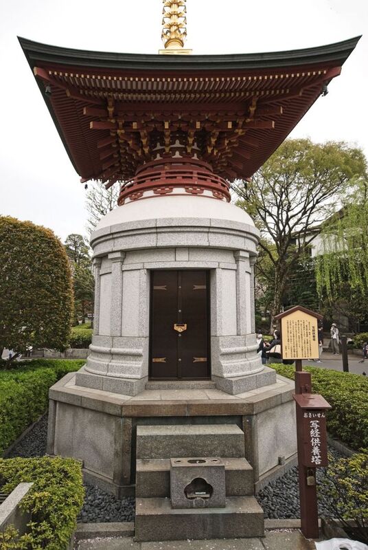 DC 23-0677-143.jpg :: Iglu Tour, Ultimate Japan & Cherry Blossom: Tokyo, Japan. Senso-ji, widely known as Asakusa Kannon Temple, is Tokyo’s oldest Buddhist temple. Located in Asakusa, one of Tokyo’s most lively and busy districts, Senso-ji is one of the most visited spiritual sites in the world. This bright and colourful temple attracts so many people from all over the world that at times it’s even hard to walk around the temple grounds. Senso-ji was founded almost one and half millennia ago, in 645. The legend says that in 628 two fishermen caught a statue of Kannon, the goddess of compassion, in the nearby Sumida River. They tried to get rid of it, but it kept coming back to them. Taking it as a sign, the head of the fishermen’s village erected Senso-ji in honour of Kannon. The temple holds the original Kannon statue; however, it can never be seen by the public and is supposedly stored safely inside 3 boxes. P.s. The memorial tower was inaugurated on October 26, 1994.  Since Showa 33 (1958), Sensoji Temple has been petitioning for the Kannon Sutra 1,000,000-volume copying movement, and it has continued to this day. In this sutra memorial tower, the believers dedicate the titles and volumes of the sutras stored in Sensoji Temple. Photo taken 31/03/2023