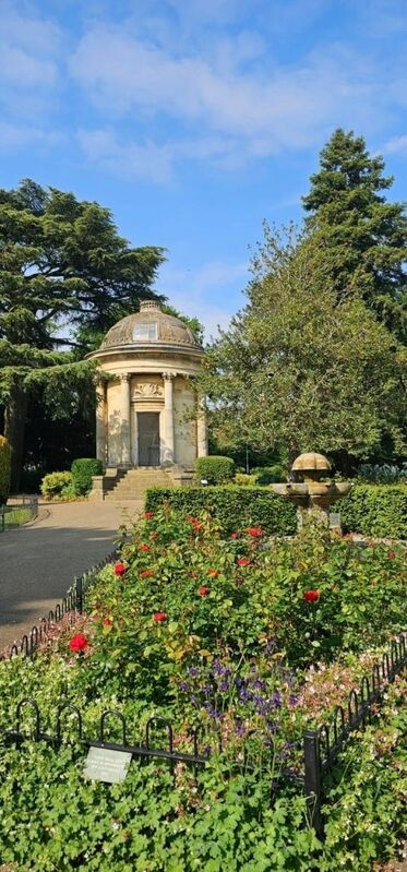 DC 24-0720-054a.jpg :: Royal Leamington Spa: The Jephson Gardens are formal gardens, together with a grassed park, in the town of Leamington Spa, Warwickshire. The gardens, once a place for the wealthy to 'take the air' and 'be seen', are found in the centre of the town on the Parade, with the River Leam flowing to the south of them. One of the town's most popular tourist attractions, they have facilities such as cafes and floral displays. The gardens began as farmland which belonged to Edward Willes, a member of the Willes family who played an important part in the shaping of early Leamington. The original gardens, covering just under 10.5 acres (42,000 m2), were laid out in 1834 at the request of the landowner with free entry to anyone between 7 am and 10 am. For the remainder of the day the gardens were open only to paying customers and patrons of a nearby spa bath house. The Jephson Memorial. This Corinthian-style temple was added to the gardens in 1849 and inside it, there is a large marble statue of Doctor Henry Jephson. The memorial is a Grade II listed building. Memorial with statue of Dr Henry Jephson on plinth within circular, domed temple. 1848-1849. Temple by DG Squirill, statue by Peter Hollins. Photo taken 19/05/2024