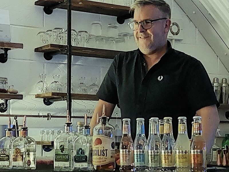 DC 24-0721-004.jpg :: Warwickshire Gin Company, Leamington Spa: Dave Blick, host for the gin tasting experience. This is a liquor store with a range of gins, rums. The range of gins here is inspired by local historical events, developing flavours that represent the unique story of the place, and making it happen by hand. Warwickshire Gin Company dabbles in craft gin distilling all things new and undiscovered. Photo taken 19/05/2024