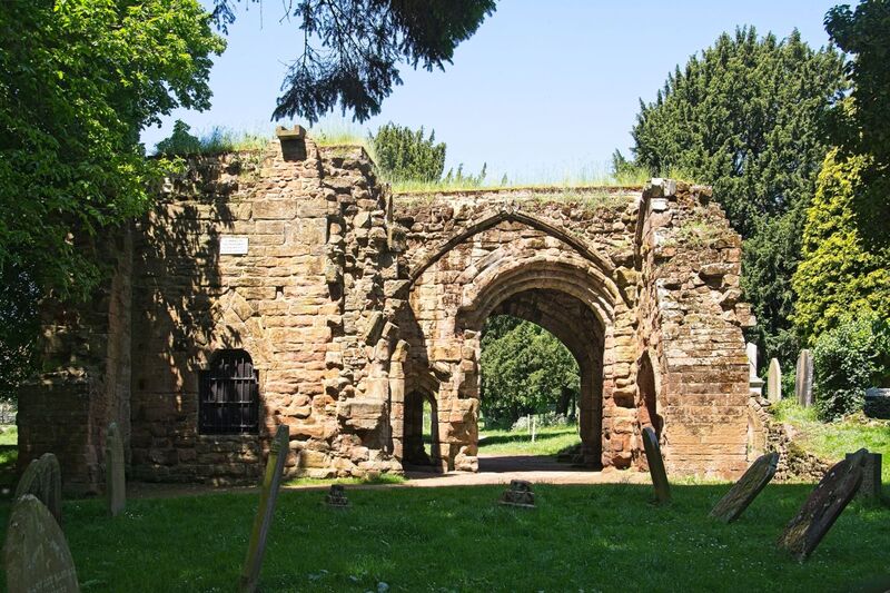 DC 24-0723-034.jpg :: St Mary's Abbey, Kenilworth, Warwickshire: The Norman and Gothic ruins of the Abbey of St. Mary the Virgin are to be found within the churchyard of St Nicholas and the open spaces of Abbey Fields. This Augustinian convent was originally founded as a Priory in 1119 by Geoffrey de Clinton on land granted to him by King Henry I. He was also the founder of Kenilworth Castle and the lives of those at the castle and Priory were inextricably linked for over 400 years. By 1447 the Priory had become one of the largest and wealthiest Augustinian houses in the Midlands and had the distinction of being raised to Abbey status by the Pope. The Abbey continued to prosper until the 1530s when King Henry VIII broke with Rome and declared himself head of the Church of England. In less than a decade every monastic house in the country had been suppressed and many destroyed. Kenilworth Abbey closed its doors for the last time on in 1538 when Abbot Simon Jeykes signed the instrument of surrender. The Gatehouse. The gatehouse, which has lost its upper floor, was the main entrance to the Abbey from the high street. Here the poor would have been given food and drink. Photo taken 19/05/2024