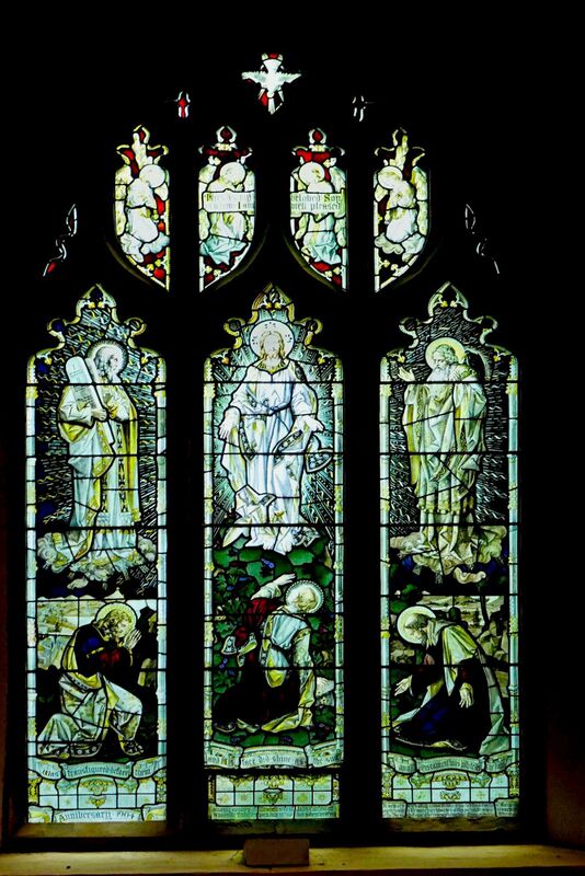 DC 24-0736-027.jpg :: Tenterden, Kent: St. Mildred's Church is an Anglican church located in Tenterden in the borough of Ashford in Kent. The church dates from about the 12th century and is Grade I heritage listed. The main tower of the church is 39.6 metres (130 feet) high and was constructed in 1461. It is dedicated to a prominent Anglo-Saxon saint, Saint Mildred, a 7th-century princess who served as the abbess of the nunnery at Minister-in-Thanet. The main tower of the church is built from Bethersden Marble, a limestone that contains thousands of brightly coloured shells. A graveyard is also present on the left-hand side of the church. Stained glass window. Transfiguration Window. TF Curtis, Ward & Hughes 1905. Photo taken 04/09/2024